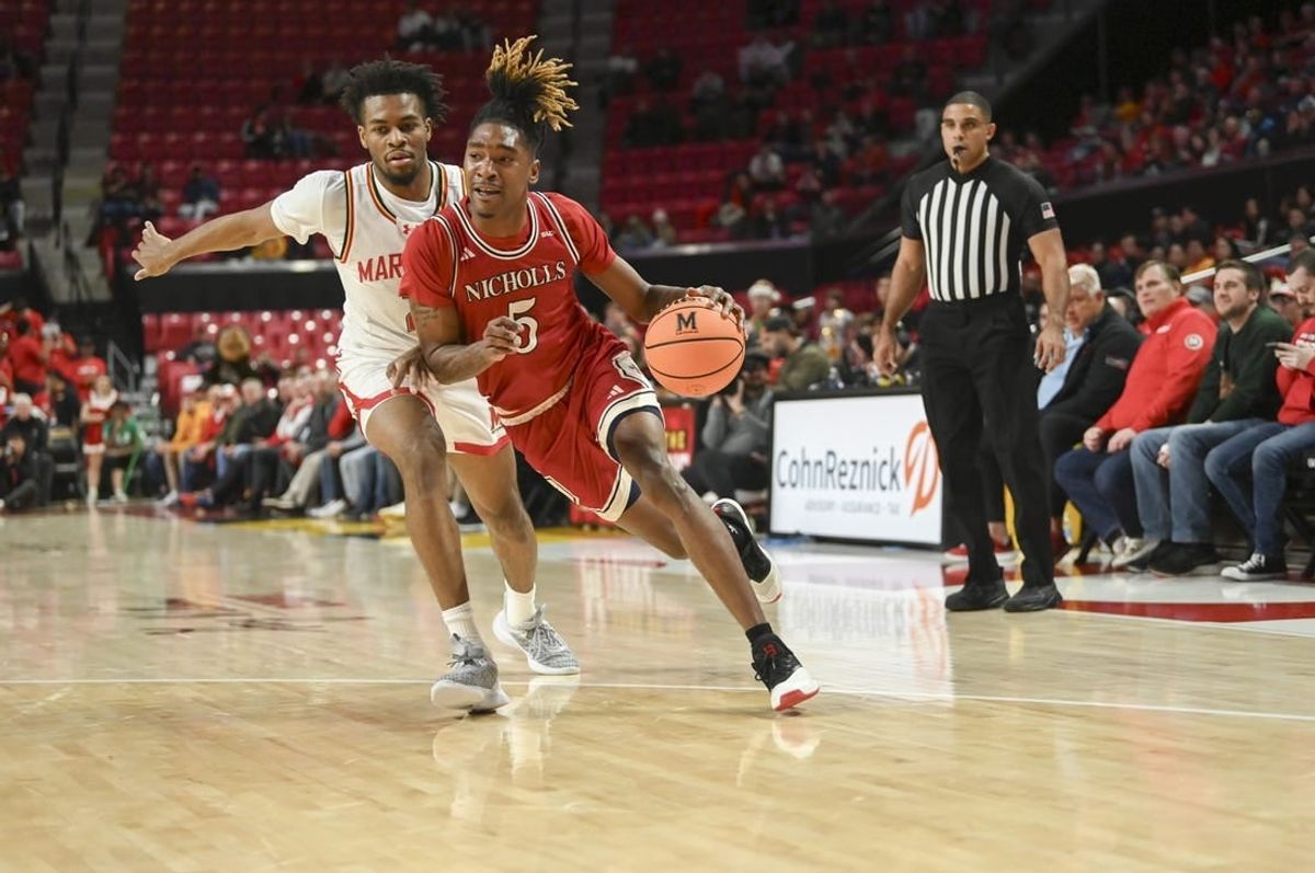 Dec 19, 2023; College Park, Maryland, USA;  Nicholls State Colonels forward Diante Smith (5) dribble by Maryland Terrapins guard Jahari Long (2) during the first half at Xfinity Center.