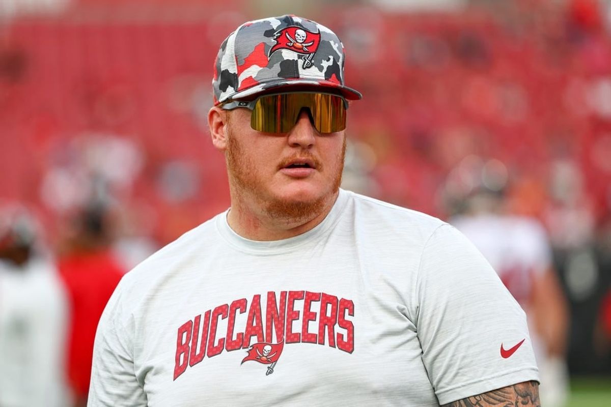 Aug 13, 2022; Tampa, Florida, USA;  Tampa Bay Buccaneers center Ryan Jensen (66) looks on from the field during warm ups before a game against the Miami Dolphins during preseason at Raymond James Stadium.