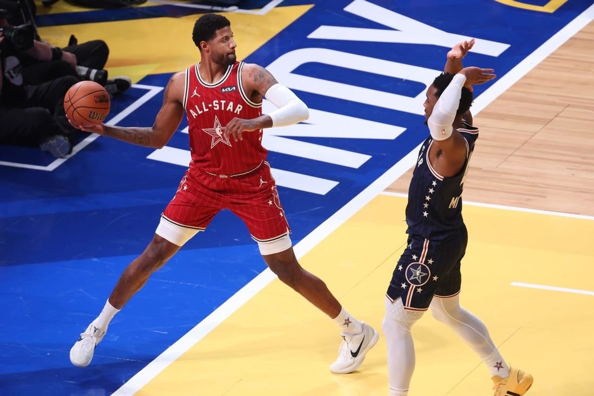 Feb 18, 2024; Indianapolis, Indiana, USA; Western Conference forward Paul George (13) of the LA Clippers attempts to save the ball against Eastern Conference guard Donovan Mitchell (45) of the Cleveland Cavaliers during the third quarter in the 73rd NBA All Star game at Gainbridge Fieldhouse.