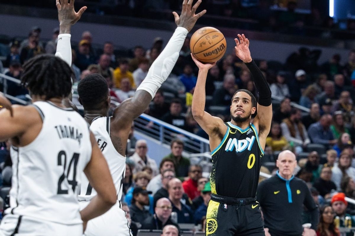 Mar 16, 2024; Indianapolis, Indiana, USA; Indiana Pacers guard Tyrese Haliburton (0) shoots the ball while Brooklyn Nets guard Dennis Schroder (17) defends in the first half at Gainbridge Fieldhouse.