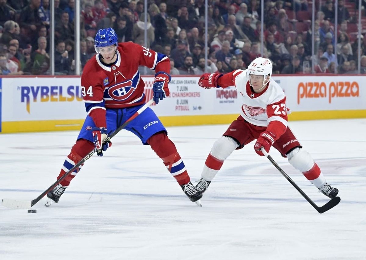 Apr 16, 2024; Montreal, Quebec, CAN; Montreal Canadiens defenseman Logan Mailloux (94) plays the puck and Detroit Red Wings forward Lucas Raymond (23) forechecks during the first period at the Bell Centre.