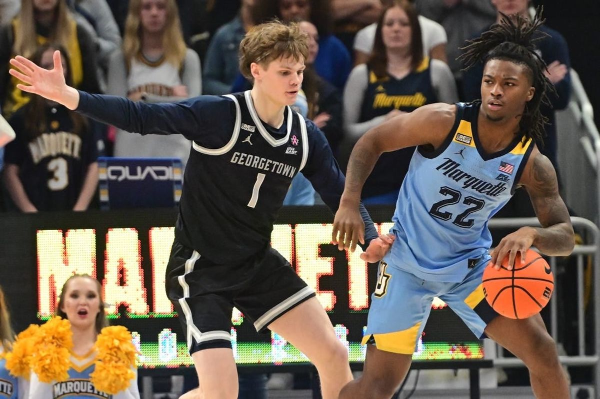 Dec 22, 2023; Milwaukee, Wisconsin, USA; Marquette Golden Eagles guard Sean Jones (22) is guarded by Georgetown Hoyas guard Rowan Brumbaugh (1) in the first half at Fiserv Forum.