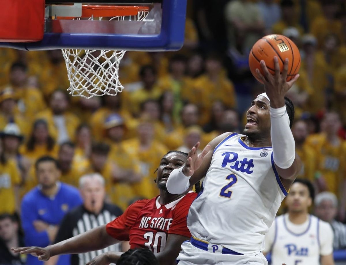 Mar 9, 2024; Pittsburgh, Pennsylvania, USA;  Pittsburgh Panthers forward Blake Hinson (2) goes to the basket past North Carolina State Wolfpack forward DJ Burns Jr. (30) during the second half at the Petersen Events Center. The Panthers won 81-73.