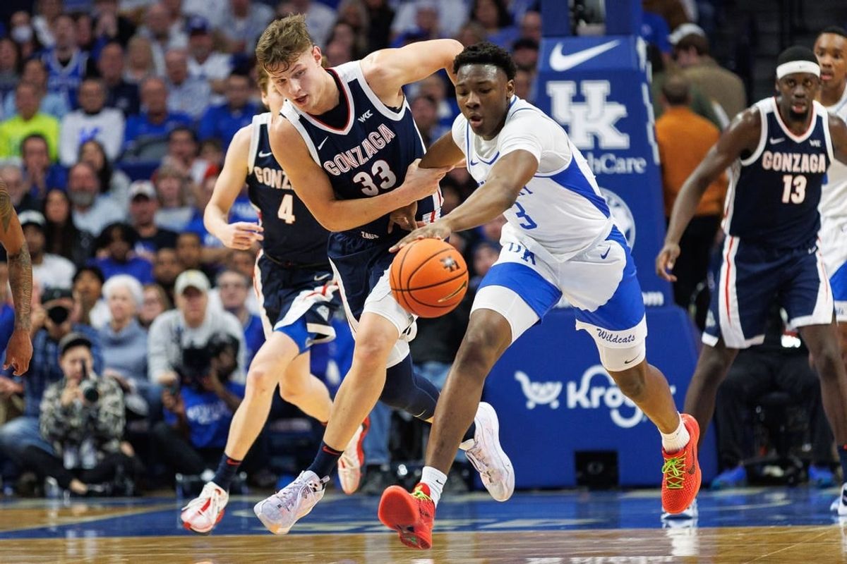 Feb 10, 2024; Lexington, Kentucky, USA; Gonzaga Bulldogs forward Ben Gregg (33) and Kentucky Wildcats guard Adou Thiero (3) chase down the ball during the first half at Rupp Arena at Central Bank Center.