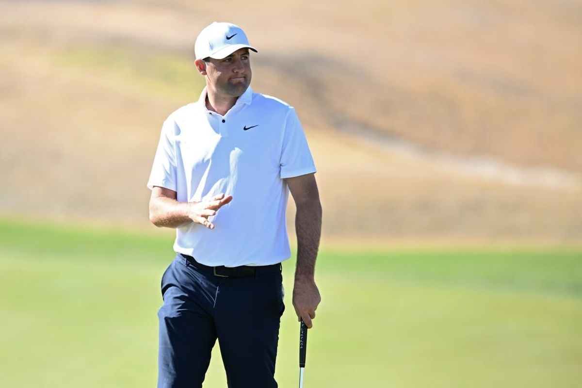 Jan 21, 2023; La Quinta, California, USA; Scottie Scheffler acknowledges the crowd after a putt on the third green during the third round of The American Express golf tournament at Pete Dye Stadium Course.