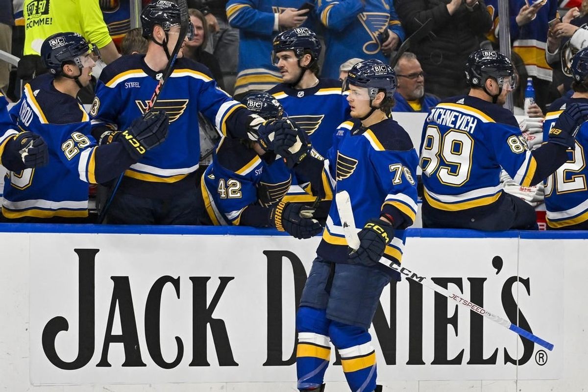 Apr 10, 2024; St. Louis, Missouri, USA;  St. Louis Blues center Zack Bolduc (76) is congratulated by teammates after scoring against the Chicago Blackhawks during the first period at Enterprise Center.
