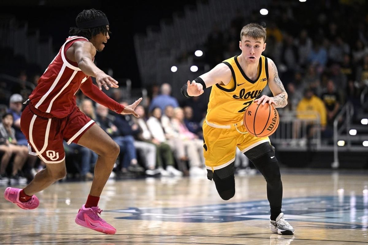 Nov 23, 2023; La Jolla, California, USA; Iowa Hawkeyes guard Brock Harding (2) dribbles the ball while defended by Oklahoma Sooners guard Javian McCollum (2) during the first half at LionTree Arena.