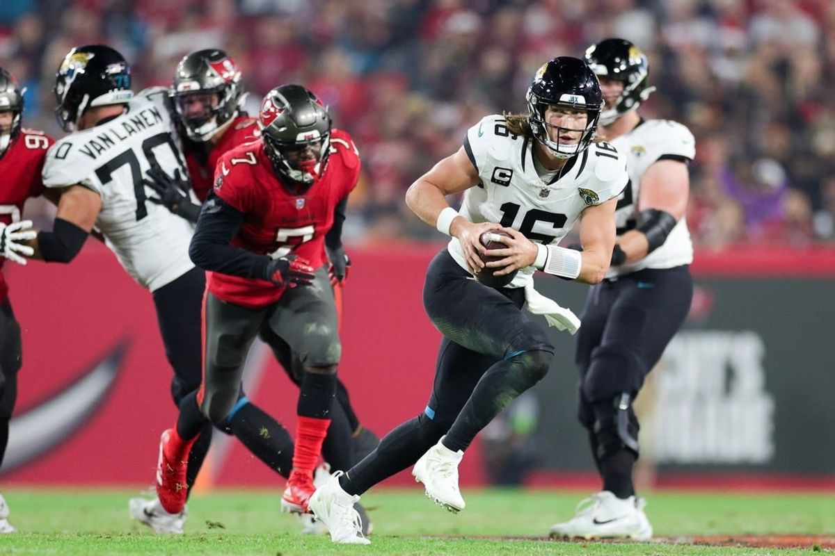 Dec 24, 2023; Tampa, Florida, USA;  Jacksonville Jaguars quarterback Trevor Lawrence (16) runs with the ball against the Tampa Bay Buccaneers in the third quarter at Raymond James Stadium.