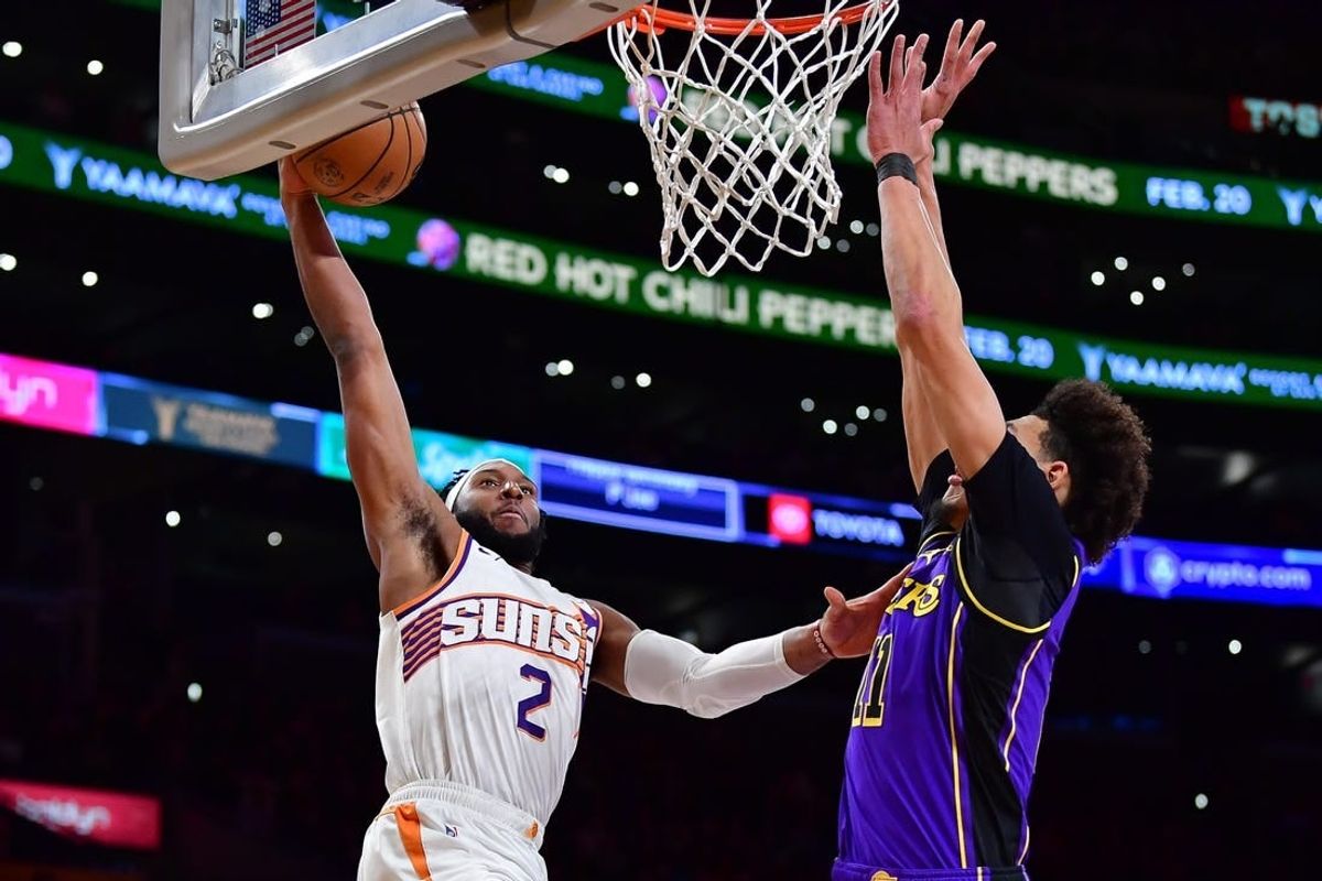 Jan 11, 2024; Los Angeles, California, USA; Phoenix Suns forward Josh Okogie (2) dunks for the basket against Los Angeles Lakers center Jaxson Hayes (11) during the first half at Crypto.com Arena.
