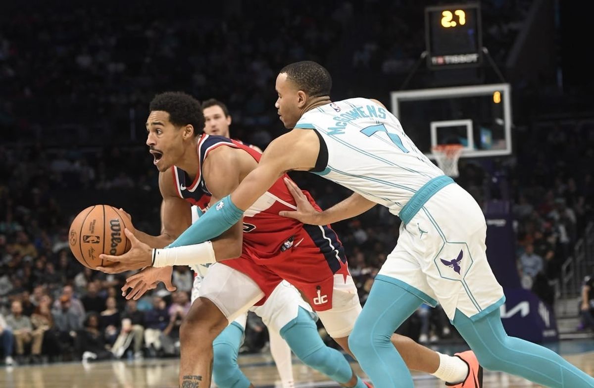 Nov 22, 2023; Charlotte, North Carolina, USA; Washington Wizards guard Jordan Poole (13) drives past Charlotte Hornets guard Bryce McGowens (7) during the second half at the Spectrum Center.