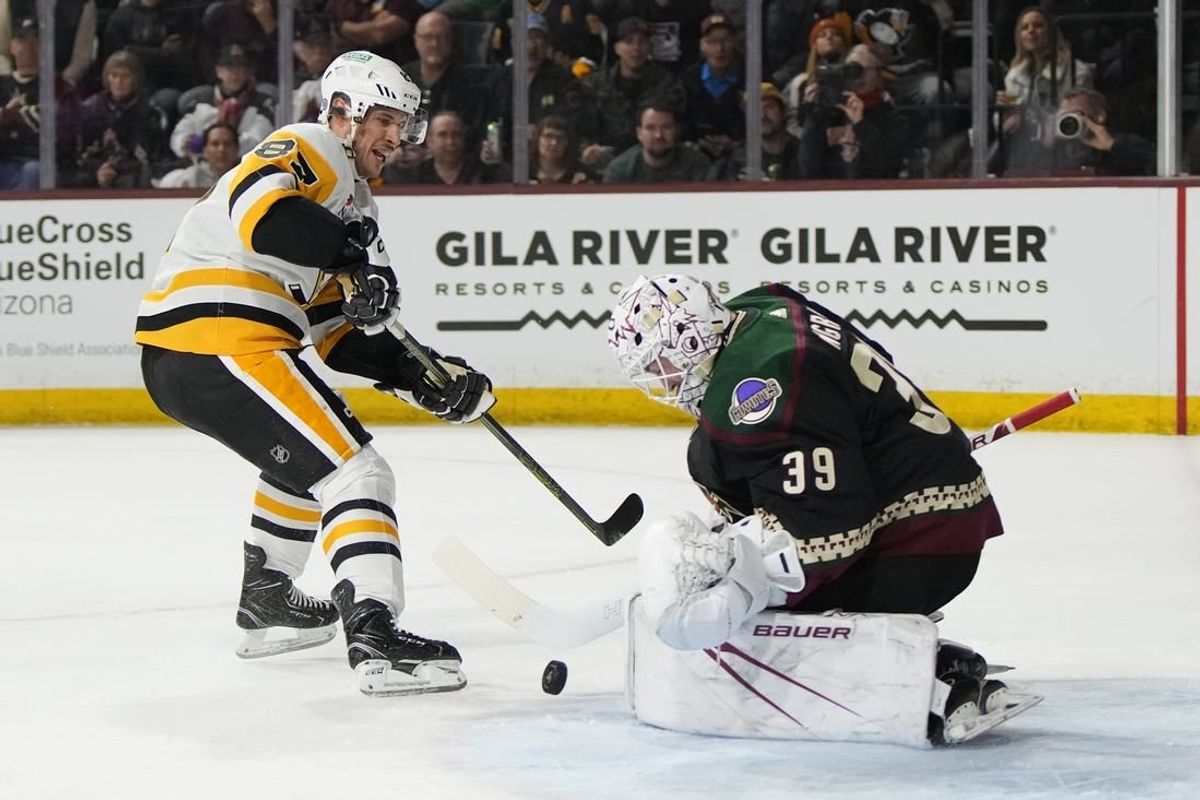 Jan 22, 2024; Tempe, Arizona, USA; Arizona Coyotes goaltender Connor Ingram (39) makes the save on Pittsburgh Penguins center Sidney Crosby (87) in the first period at Mullett Arena.