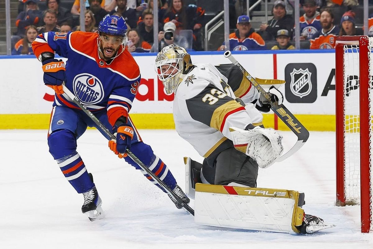 Apr 10, 2024; Edmonton, Alberta, CAN; Edmonton Oilers forward Evander Kane (91) looks for a pass beside Vegas Golden Knights goaltender Adin Hill (33) during the first period at Rogers Place.