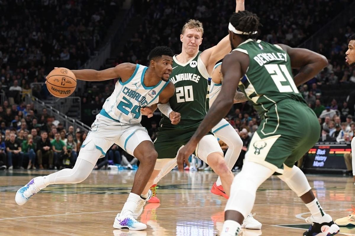 Feb 9, 2024; Milwaukee, Wisconsin, USA; Charlotte Hornets forward Brandon Miller (24) drives against  Milwaukee Bucks guard AJ Green (20) and guard Patrick Beverley (21) in the first half at Fiserv Forum.