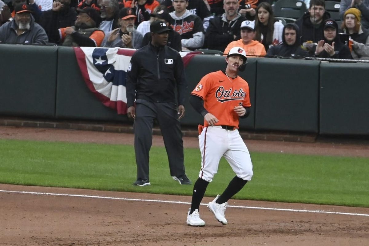 Mar 30, 2024; Baltimore, Maryland, USA; ]Baltimore Orioles left fielder Austin Hays (21) reacts after hitting a sixth inning  rbi single against the Los Angeles Angels  at Oriole Park at Camden Yards.