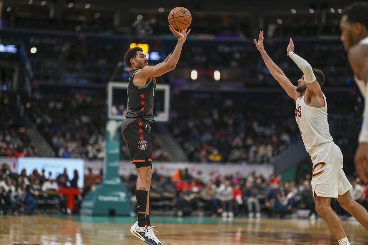Feb 25, 2024; Washington, District of Columbia, USA;  Washington Wizards guard Jordan Poole (13) shoots over Cleveland Cavaliers forward Georges Niang (20) during the second  half at Capital One Arena.
