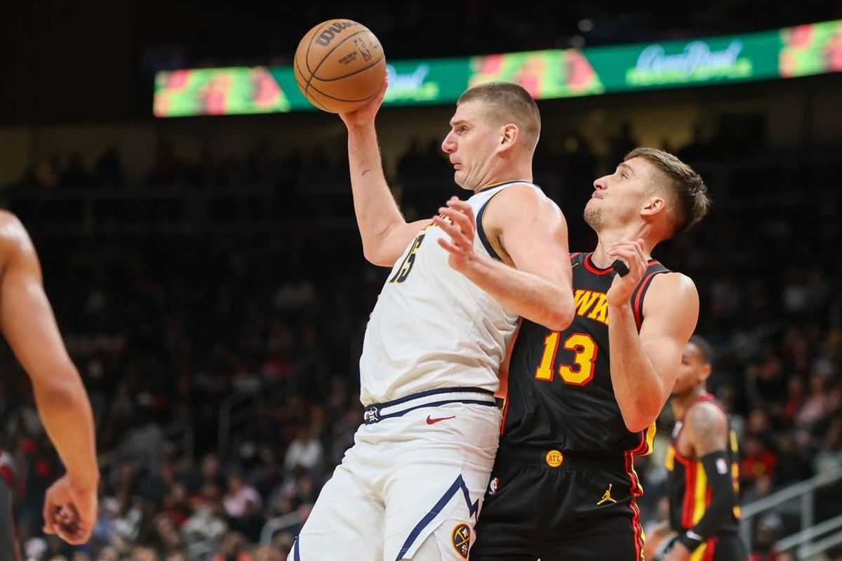 Dec 11, 2023; Atlanta, Georgia, USA; Denver Nuggets center Nikola Jokic (15) is defended by Atlanta Hawks guard Bogdan Bogdanovic (13) in the second quarter at State Farm Arena.