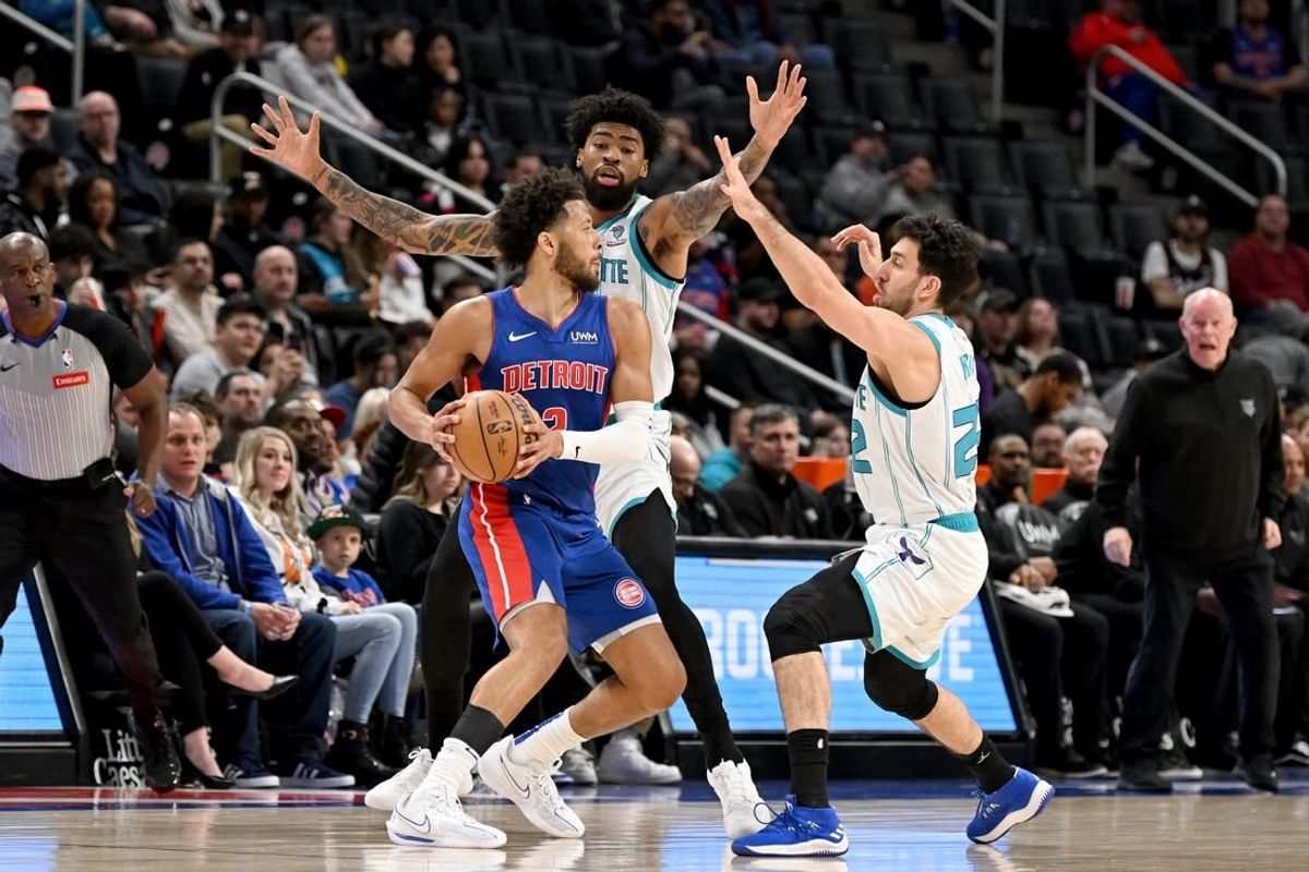 Mar 11, 2024; Detroit, Michigan, USA;   Detroit Pistons guard Cade Cunningham (2) is double teamed by Charlotte Hornets guard Vasilije Micic (22) and center Nick Richards (4) in the first quarter at Little Caesars Arena.