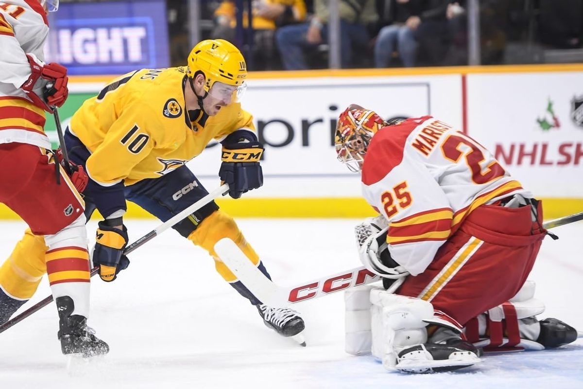 Nov 22, 2023; Nashville, Tennessee, USA; Calgary Flames goaltender Jacob Markstrom (25) blocks the shot of Nashville Predators center Colton Sissons (10) during the first period at Bridgestone Arena.