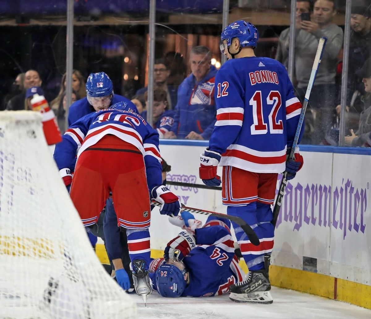 Nov 27, 2023; New York, New York, USA; New York Rangers right wing Kaapo Kakko (24) is helped by a trainer on the ice after an injury to his left leg during the second period against the Buffalo Sabres at Madison Square Garden.