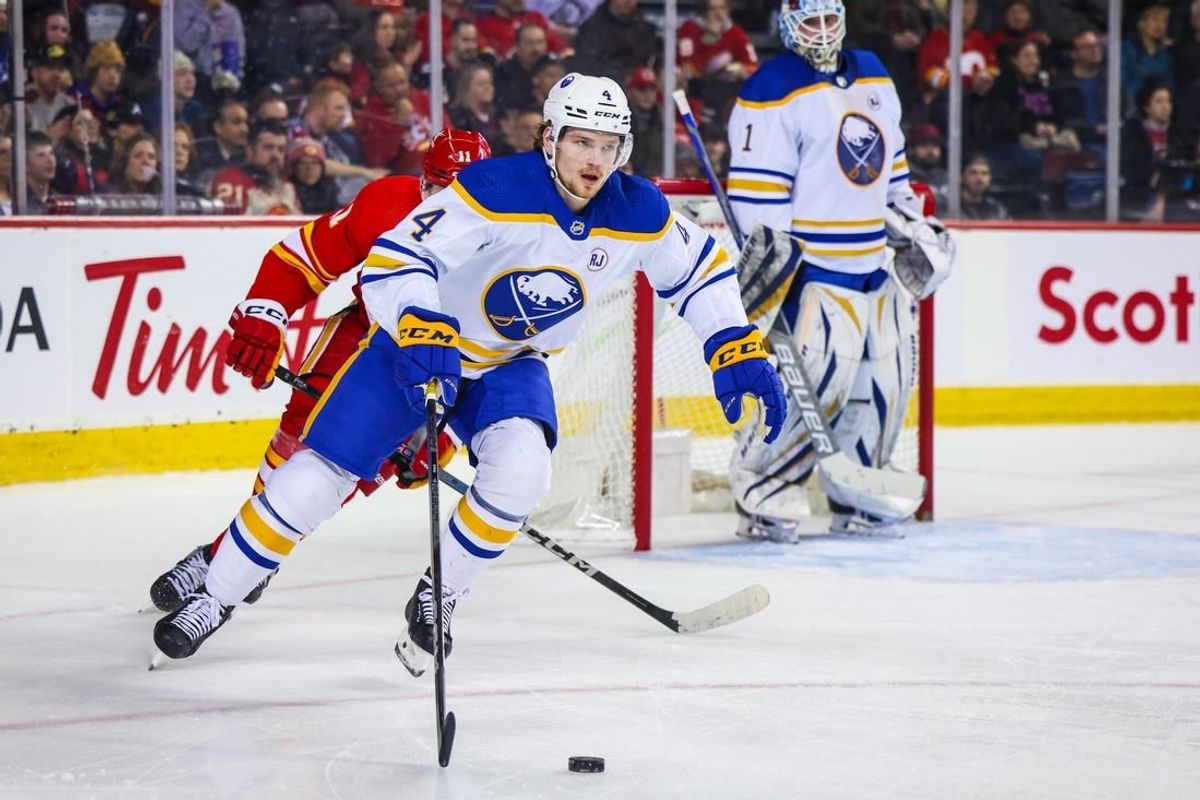 Mar 24, 2024; Calgary, Alberta, CAN; Buffalo Sabres defenseman Bowen Byram (4) controls the puck against the Calgary Flames during the second period at Scotiabank Saddledome.