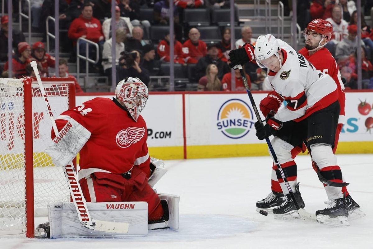 Jan 31, 2024; Detroit, Michigan, USA;  Ottawa Senators left wing Brady Tkachuk (7) tries to score on Detroit Red Wings goaltender Alex Lyon (34) in the first period at Little Caesars Arena.