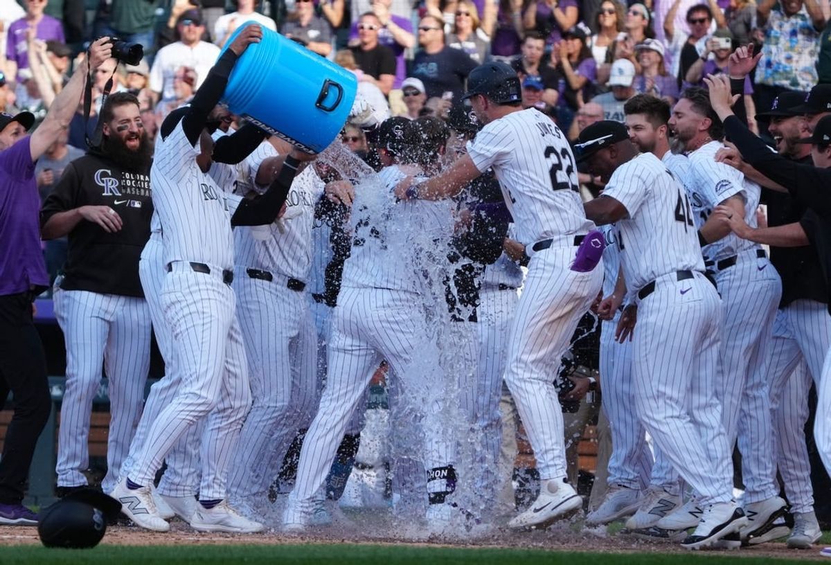 Apr 5, 2024; Denver, Colorado, USA; Colorado Rockies third base Ryan McMahon (24) celebrates his walk off grand slam in the ninth inning against the Tampa Bay Rays at Coors Field.