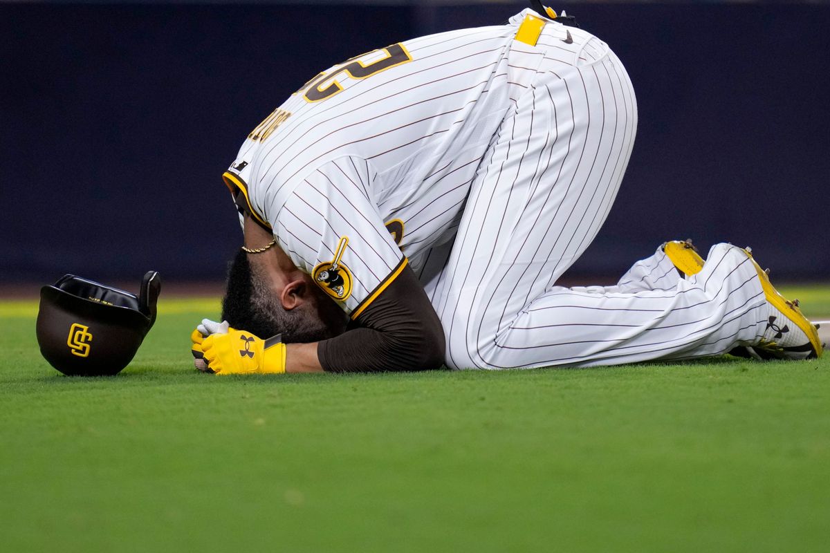 Juan Soto reacts after being hit by a foul ball while batting during the seventh inning