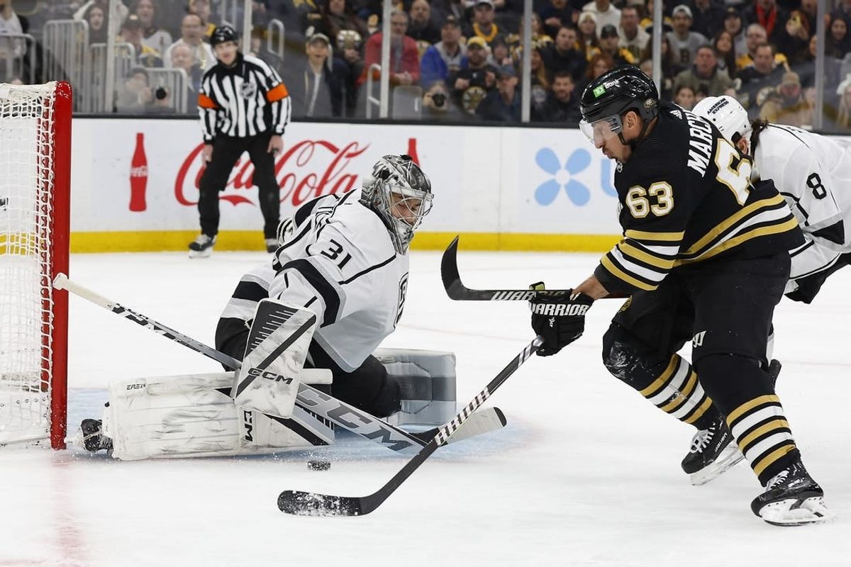Feb 17, 2024; Boston, Massachusetts, USA; Boston Bruins left wing Brad Marchand (63) goes for a rebound in front of Los Angeles Kings goaltender David Rittich (31) during the first period at TD Garden.