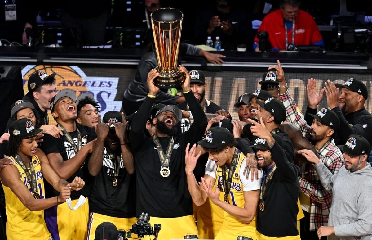 Dec 9, 2023; Las Vegas, Nevada, USA; Los Angeles Lakers forward LeBron James (23) hoists the NBA Cup and celebrates with teammates after winning the NBA In-Season Tournament Championship game against the Indiana Pacers at T-Mobile Arena.