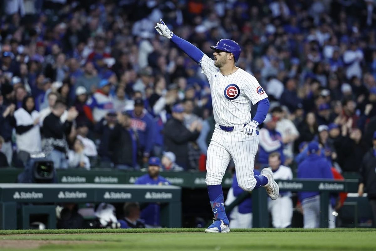 Apr 23, 2024; Chicago, Illinois, USA; Chicago Cubs outfielder Mike Tauchman (40) rounds the bases after hitting a three-run home run against the Houston Astros during the first inning at Wrigley Field.