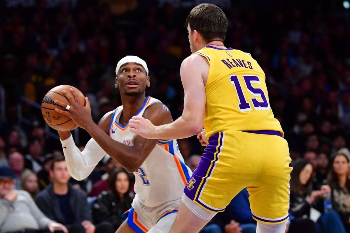 Mar 4, 2024; Los Angeles, California, USA;  Oklahoma City Thunder guard Shai Gilgeous-Alexander (2) controls the ball against Los Angeles Lakers guard Austin Reaves (15) during the second half at Crypto.com Arena.