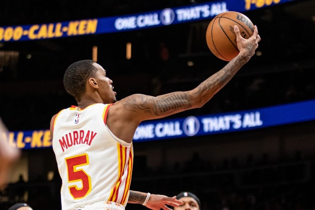 Jan 17, 2024; Atlanta, Georgia, USA; Atlanta Hawks guard Dejounte Murray (5) lays in the ball against Orlando Magic during fourth quarter at State Farm Arena.