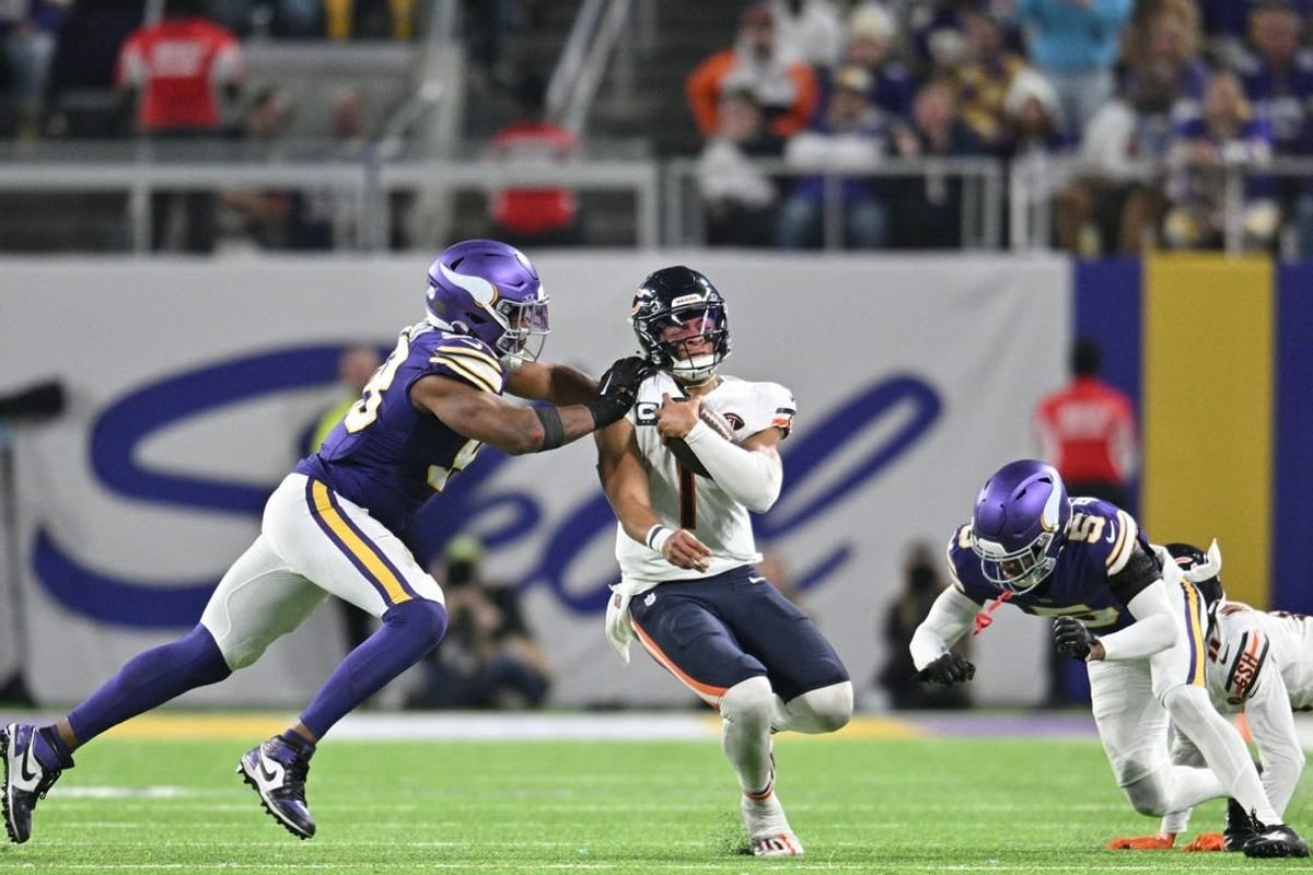 Nov 27, 2023; Minneapolis, Minnesota, USA; Chicago Bears quarterback Justin Fields (1) is tackled by Minnesota Vikings linebacker Danielle Hunter (99) and cornerback Mekhi Blackmon (5) as wide receiver Darnell Mooney (11) looks to block during the fourth quarter at U.S. Bank Stadium.