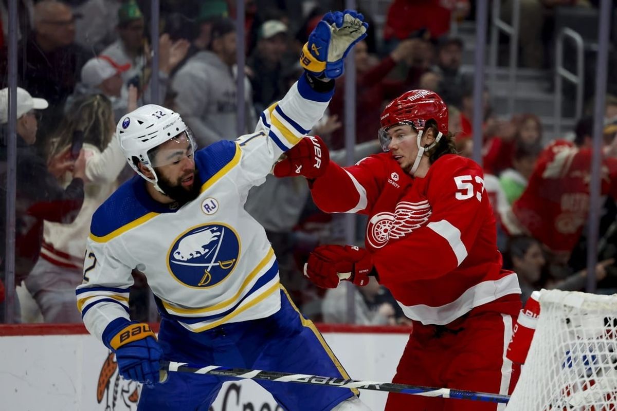 Mar 16, 2024; Detroit, Michigan, USA;  Detroit Red Wings defenseman Moritz Seider (53) shoves Buffalo Sabres left wing Jordan Greenway (12) in the third period at Little Caesars Arena.