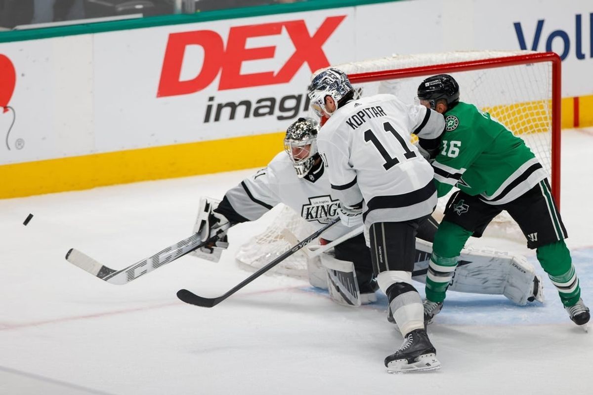 Mar 16, 2024; Dallas, Texas, USA; Los Angeles Kings goaltender David Rittich (31) fights off a shot with center Anze Kopitar (11) and Dallas Stars center Joe Pavelski (16) in front of his goal during the first period at American Airlines Center.