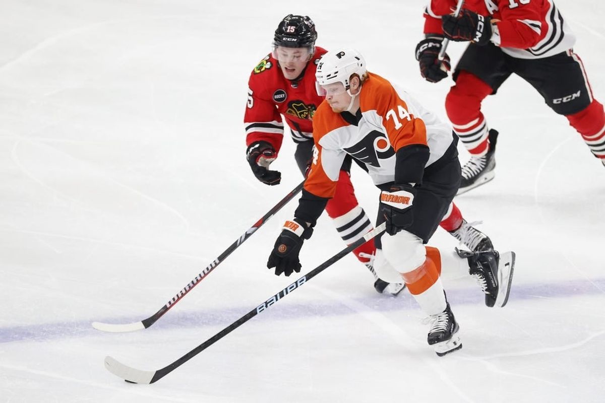 Feb 21, 2024; Chicago, Illinois, USA; Chicago Blackhawks right wing Joey Anderson (15) defends against Philadelphia Flyers right wing Owen Tippett (74) during the second period at United Center.