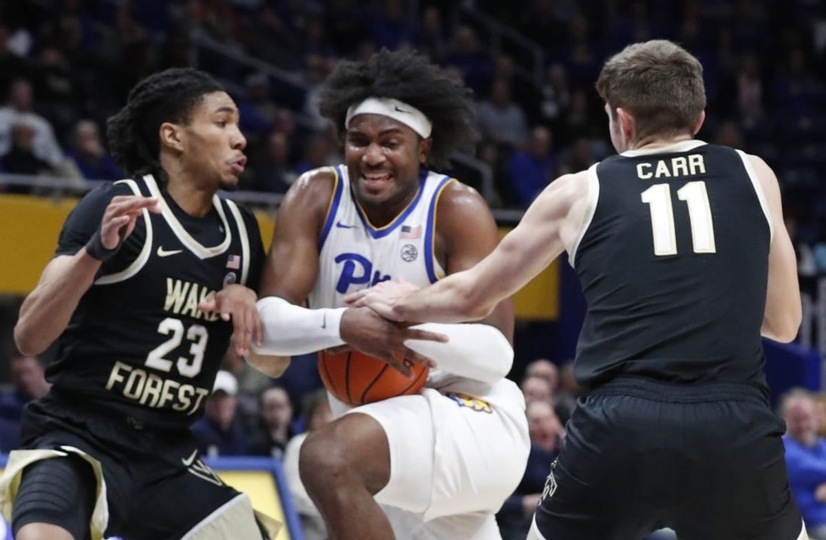 Jan 31, 2024; Pittsburgh, Pennsylvania, USA; Pittsburgh Panthers forward Blake Hinson (middle) goes to the basket against Wake Forest Demon Deacons guard Hunter Sallis (23) and forward Andrew Carr (11) during the first half at the Petersen Events Center.