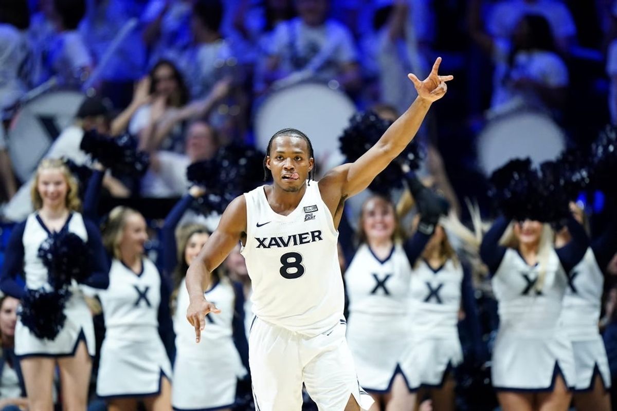 Dec 9, 2023; Cincinnati, Ohio, USA; Xavier Musketeers guard Quincy Olivari (8) reacts after a made three-point basket in the second half against the Cincinnati Bearcats at Cintas Center.