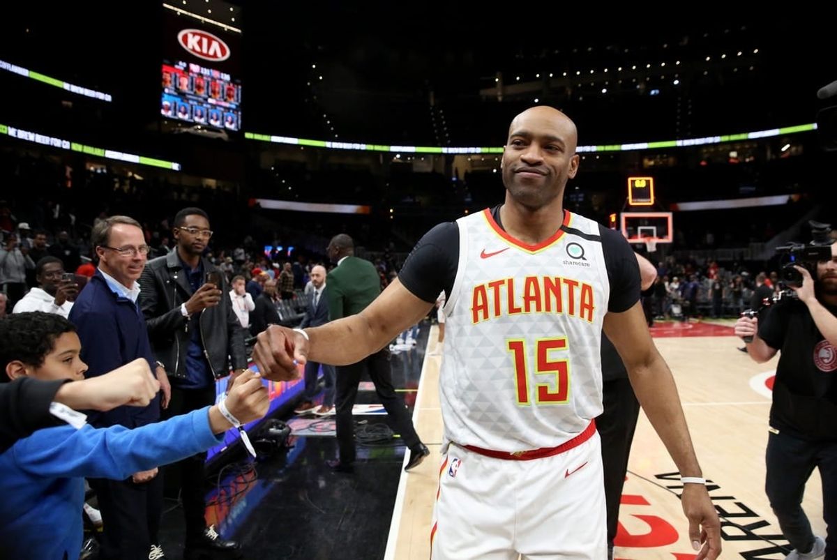 Mar 11, 2020; Atlanta, Georgia, USA; Atlanta Hawks guard Vince Carter (15) fist bumps fans after an overtime loss to the New York Knicks at State Farm Arena.