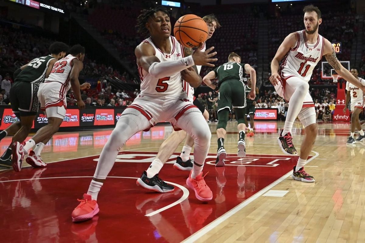 Jan 21, 2024; College Park, Maryland, USA;  Maryland Terrapins guard DeShawn Harris-Smith (5) reaches for a loose ball during the first half against the Michigan State Spartans at Xfinity Center.