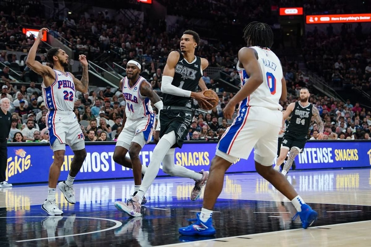 Apr 7, 2024; San Antonio, Texas, USA;  San Antonio Spurs center Victor Wembanyama (1) drives in for a shots in front of Philadelphia 76ers guard Cameron Payne (22) in the first half at Frost Bank Center.