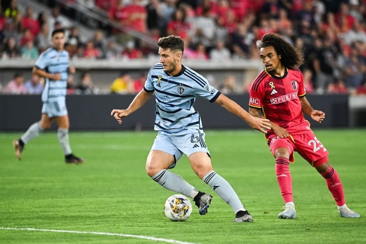 Sep 30, 2023; St. Louis, Missouri, USA; Sporting Kansas City midfielder Nemanja Radoja (6) shields the ball from St. Louis City midfielder Aziel Jackson (25) during the second half at CITYPARK.