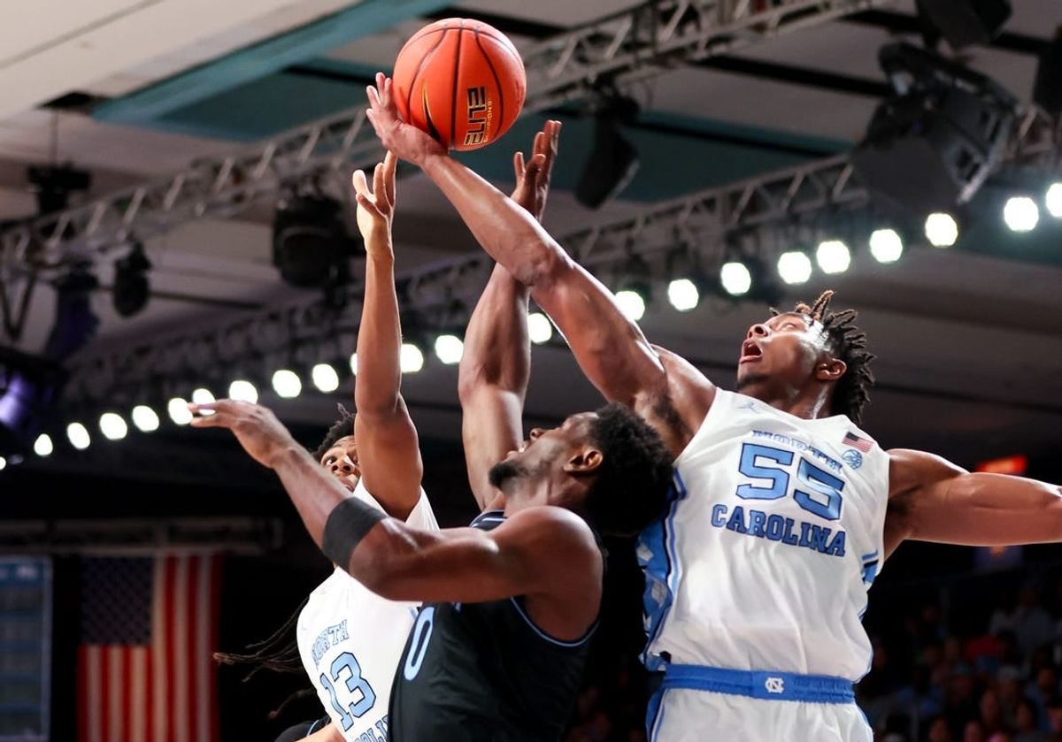 Nov 23, 2023; Paradise Island, BAHAMAS;  North Carolina Tar Heels forward Harrison Ingram (55) and North Carolina Tar Heels forward Jalen Washington (13) battle for the ball with Villanova Wildcats guard TJ Bamba (0) during the first half at Imperial Arena.
