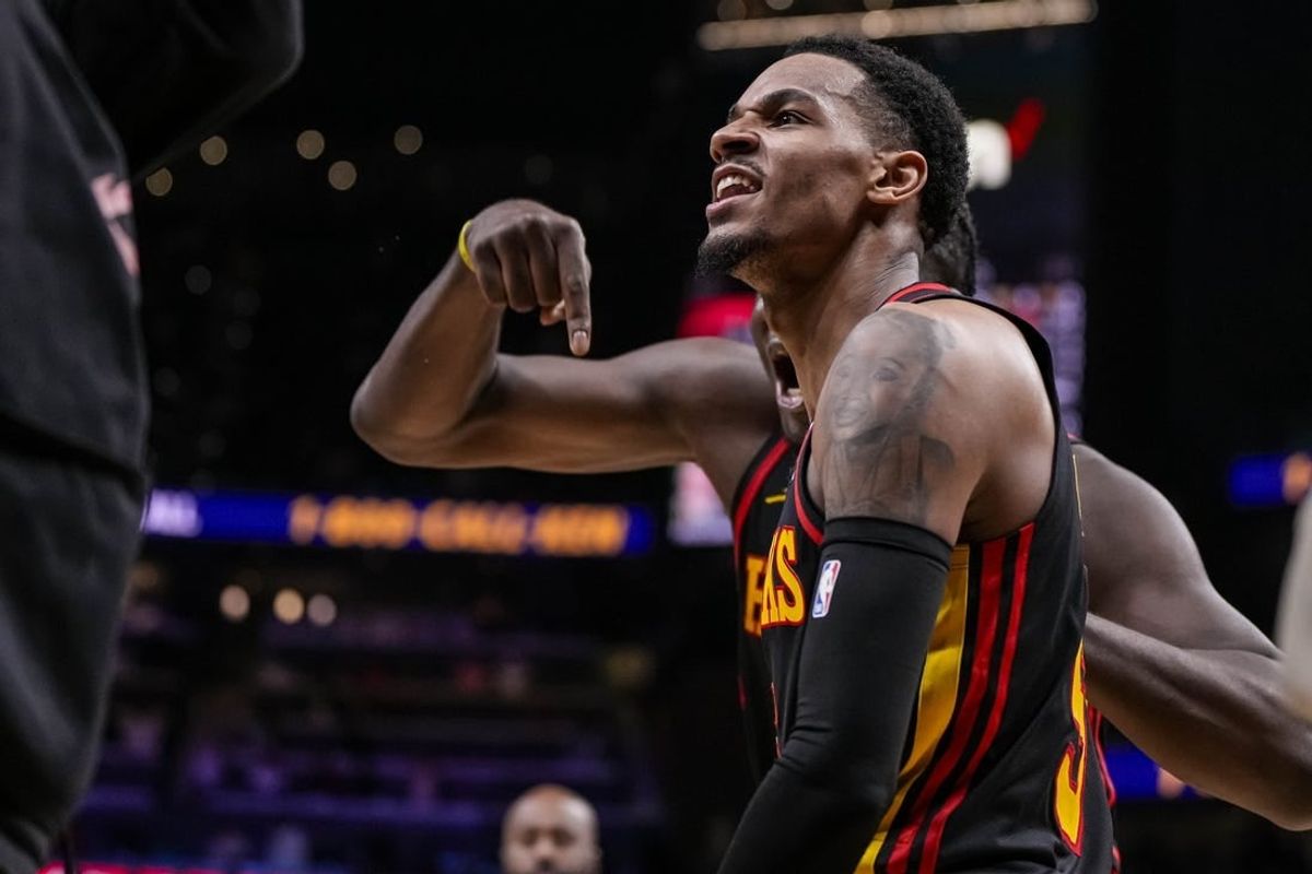 Mar 28, 2024; Atlanta, Georgia, USA; Atlanta Hawks guard Dejounte Murray (5) reacts after making a go ahead basket with less than a second left against the Boston Celtics during overtime at State Farm Arena.