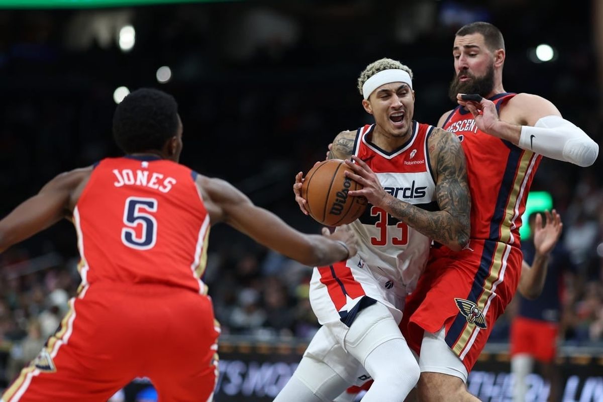 Dec 13, 2023; Washington, District of Columbia, USA; Washington Wizards forward Kyle Kuzma (33) drives to the basket as New Orleans Pelicans center Jonas Valanciunas (17) defends in the second quarter at Capital One Arena.