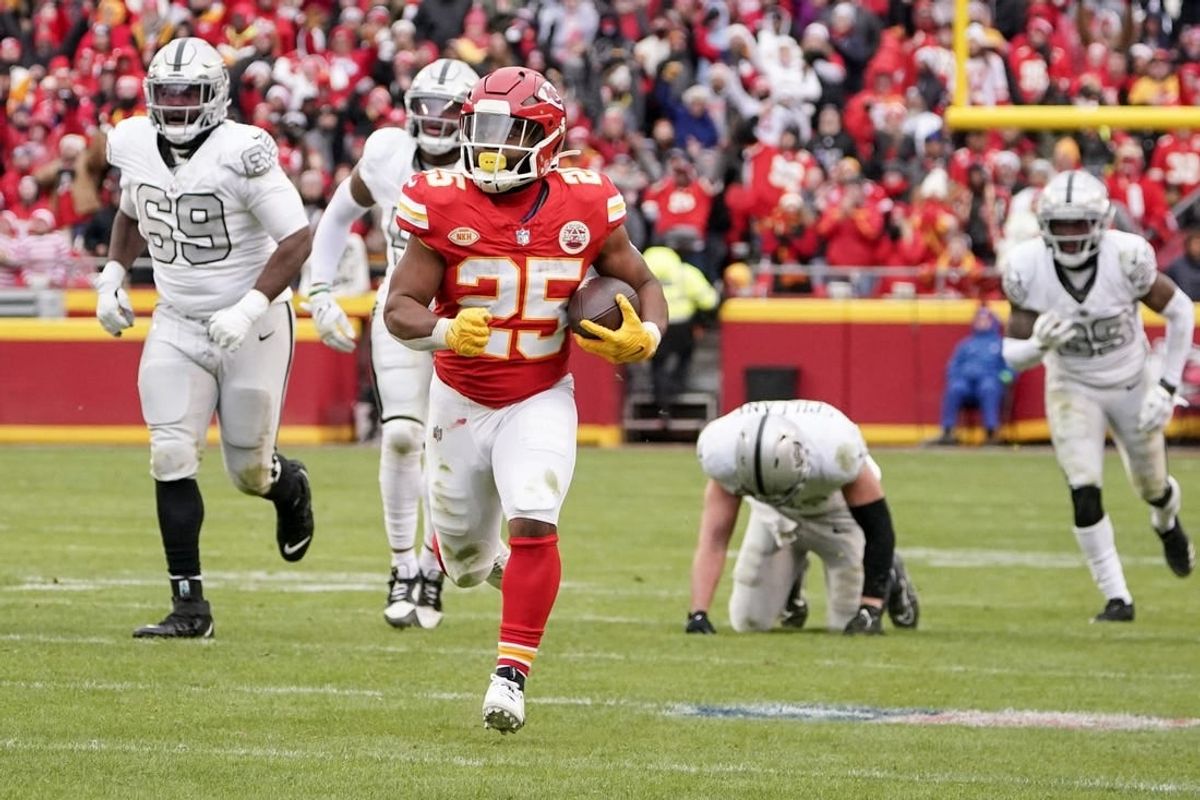 Dec 25, 2023; Kansas City, Missouri, USA; Kansas City Chiefs running back Clyde Edwards-Helaire (25) runs the ball against the Las Vegas Raiders during the game at GEHA Field at Arrowhead Stadium.