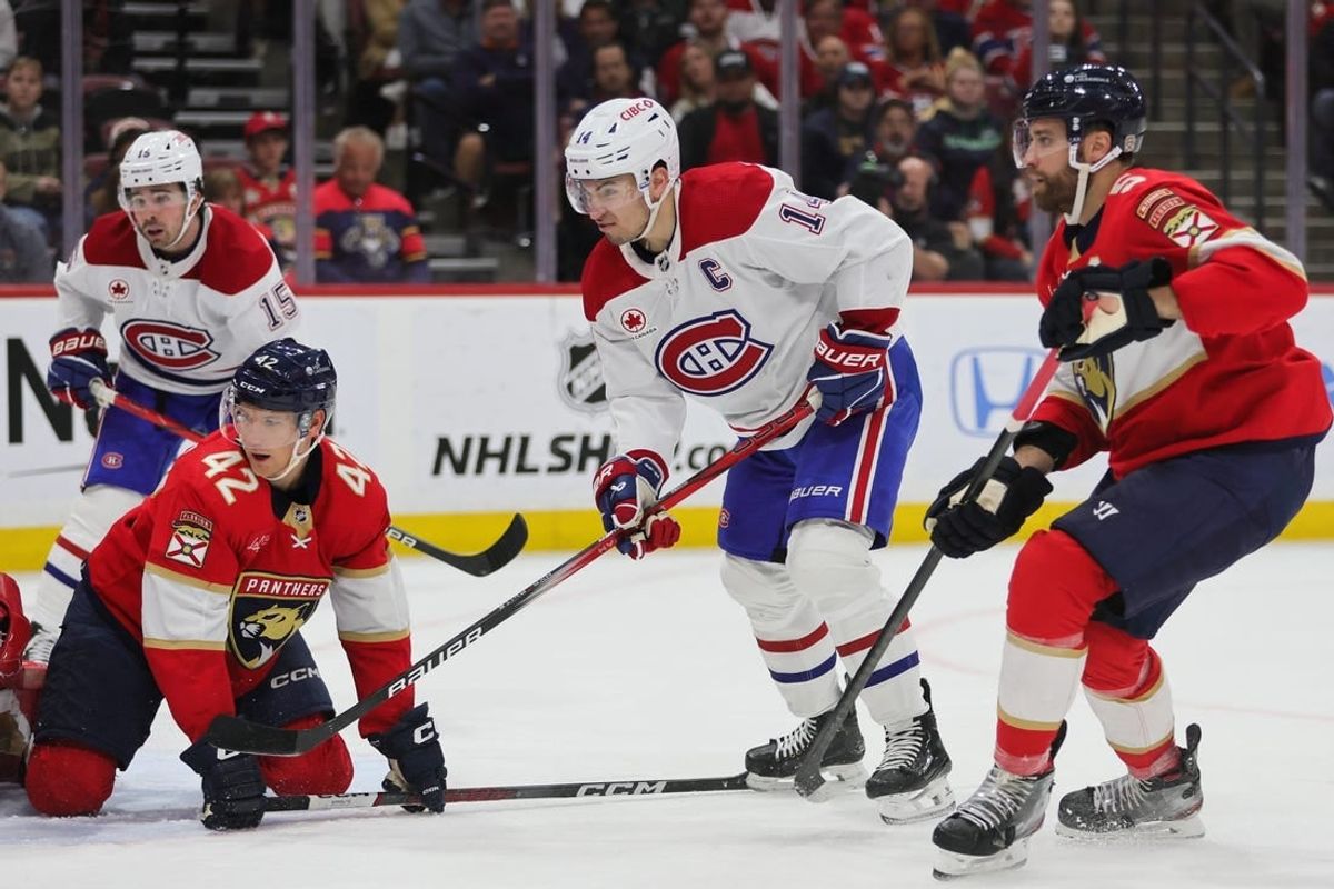 Feb 29, 2024; Sunrise, Florida, USA; Montreal Canadiens center Nick Suzuki (14) watches his shot against the Florida Panthers during the first period at Amerant Bank Arena.