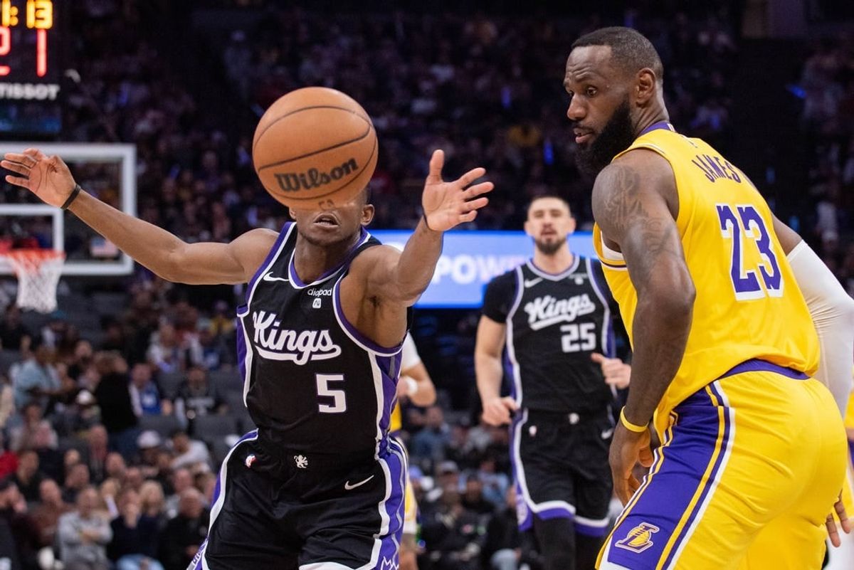 Mar 13, 2024; Sacramento, California, USA; Sacramento Kings guard De'Aaron Fox (5) and Los Angeles Lakers forward LeBron James (23) go for the loose ball during the second quarter at Golden 1 Center.