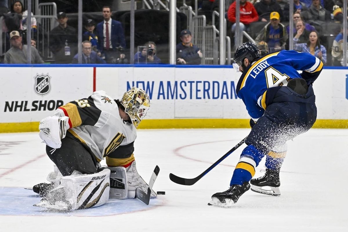 Mar 25, 2024; St. Louis, Missouri, USA;  Vegas Golden Knights goaltender Logan Thompson (36) defends the net against St. Louis Blues defenseman Nick Leddy (4) during the second period at Enterprise Center.