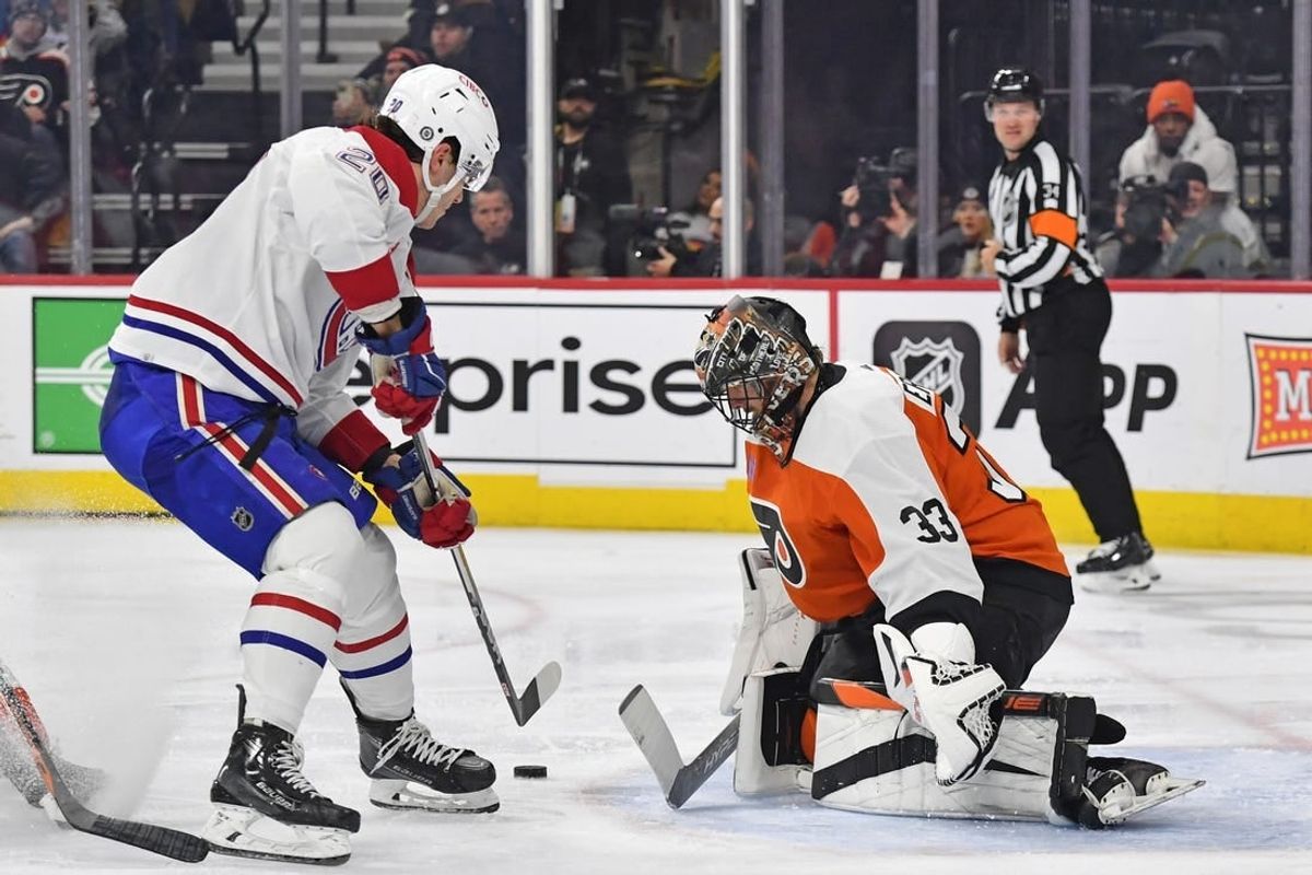 Jan 10, 2024; Philadelphia, Pennsylvania, USA; Philadelphia Flyers goaltender Samuel Ersson (33) makes a save against Montreal Canadiens left wing Juraj Slafkovsky (20) during the second period at Wells Fargo Center.